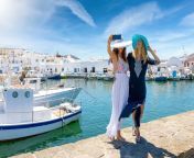 two attractive female traveler friends taking selfie photos idyllic fishing village naousa island paros greece 135736656.jpg from village selfi