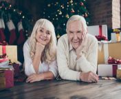 two cheerful beautiful positive people grey haired husband w wife lying floor near decorated fir tree many bow ribbon 143118826.jpg from husband and w