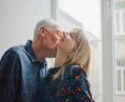 hot sexy middle aged woman enjoying kissing her elderly husband standing near opened window inside their home hot sexy 151328274.jpg from hot aged romance