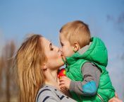 mom kissing son her autumn park family time happiness childhood motherhood outdoor activities 79188784.jpg from mom kissing son