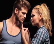 blonde woman holding her boyfriend chin close up women finger looking each other black background 44381327.jpg from chin bf