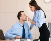 businesswoman seducing male employee flirting touching his face workplace modern office sexual relationship harassment 183507074.jpg from female boss seducing male secretary