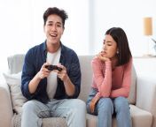 discontented asian wife looking husband playing video game indoors gaming addiction problem discontented asian wife looking 197667784.jpg from backshots before asian wife goes to bed 私は彼女の良いセックスをしました