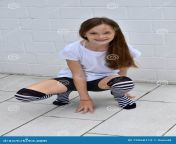 teenage girl crouching friendly striped over knee stockings ground 72560113.jpg from icomsex