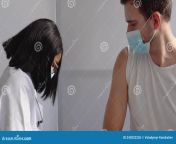 young indian nurse giving covid flu antivirus vaccine shot to male patient wear face mask protection pakistani virus 243022226.jpg from ami ami pakistani viral jpg