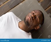 young black man lying dead body exercise photo corpse pose his eyes closed savasana working out resting 110396874.jpg from dead body