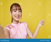 dreamy cute young lady recording self video showing arm empty space isolated yellow background friendly happy woman takes 301662728.jpg from young cute showing all recorded combined video mp4