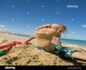 little girl on beach showing sand crusted foot b2hdnk.jpg from little sand crusted feet