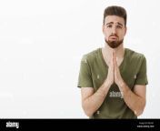 please i beg you portrait of cute charming bearded male in need holding hands in pray supplicating pouting and frowning looking upset as asking favour or help hopefully over white background rb1651.jpg from beg in