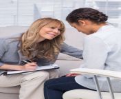 woman therapist smiling at person in therapy.jpg from theraphy