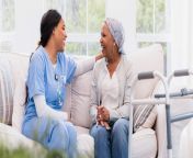 hospice nursean informative career guide a picture of a hospice nurse laughing with a sick patient in her home.jpg from hospice
