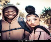 a college age african american man in hoodie along side a beautiful female coed of color with trendy cool up do on campus enjoying student life 2b8e415.jpg from do coed