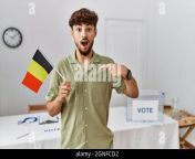young arab man at political campaign election holding belgium flag pointing finger to one self smiling happy and proud 2gnfcd2.jpg from arab self fingering