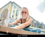 beautiful athletic young girl in sportswear doing exercises for stretching on the street the element of gymnastics doing splits concrete w5g5hb.jpg from naturist young gymnastics