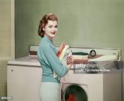 portrait of an unidentified model who poses in front of a washing machine and dryer with an jpgs612x612wgik20ckynccevj5sozo0t1y7scjgfjgo9acymsh5lcqyo y08 from family archive washing machine