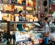 latin american man working at a delicatessen suggeting a type of cheese to female customer jpgs612x612wgik20crsuaocwhvbzznckgvj2ekbgmoeuyl3ck r92r9q0k.i from hd local jpg