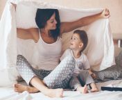 young mother with her 2 years old little son dressed in pajamas are relaxing and playing in the bed at the weekend together lazy morning.jpg from sleep mom share bed son sex vedio