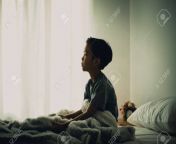98203493 dark tone color and sad mood of young asian thai boy sitting alone on a white bed in a white bedroom.jpg from young alone mood