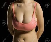 129952935 woman with big in small and tight bra on black background.jpg from big tit small bra