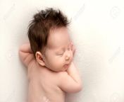 195870545 top view of a newborn baby girl lying without clothes on a white bed beautiful portrait back of a.jpg from naked little without clothes