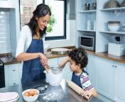 50604380 smiling mother cooking with her son in kitchen at home.jpg from mom son in kichen