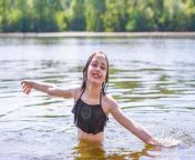 teenage girl swims in the river in summer happy child bathes photo.jpg from young bath in river