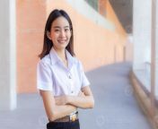 portrait young asian beautiful and pretty thai girl student in uniform is smiling looking at camera and arms crossed to present something confidently in university background photo.jpg from student thai young