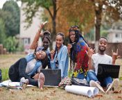 group of five african college students spending time together on campus at university yard black afro friends sitting on grass and studying with laptops photo.jpg from easy black students