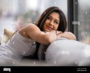 lifestyle portrait of a beautiful young indian woman relaxing at home in urban apartment 2apk48w.jpg from pretty indian babe home