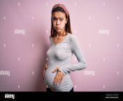 young beautiful teenager girl pregnant expecting baby over isolated pink background puffing cheeks with funny face mouth inflated with air crazy exp 2c4t59c.jpg from pregnant cheek