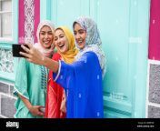 happy arabian friends using smartphone for making selfie story on social network app young girls with hijab having fun with new trend technology f 2b0btxr.jpg from 2 haijabi having some fun each other