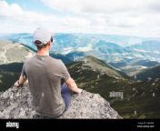 young strong man sitting on the rock at the top of the mountains peak enjoying the view hiking concept 2gb6pax.jpg from hiking ptaxx vedosttp desimajay peperonity