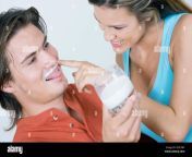 close up of a young woman touching milk mustache of a young man and smiling 2efc0by.jpg from wife touching milk