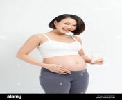 pregnant woman drinking milk on the white background 2d6jx41.jpg from www japanese pregnant milk big breasts xxx 3gp com