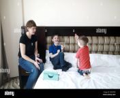 mother with sons on bed in hotel room in the morning 2de70pd.jpg from real son mom bed room