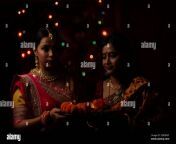 two beautiful indian bengali women in indian traditional dress worshipping with flowers in darkness on diwali evening indian lifestyle and diwali 2de0dgt.jpg from indian bengali women sex videosসরাসরি বাসর