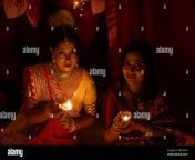 two beautiful indian bengali women in indian traditional dress lightening diwali lamps sitting on the floor on diwali evening indian lifestyle 2de1adh.jpg from bangli purnima xxndian sasur aur bahu ka