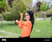smiling arab woman stretching in public park 2g4x5hk.jpg from arab hijab public