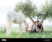 young woman sitting with boyfriend by horse at field 2g4xdpy.jpg from hors girlbf in