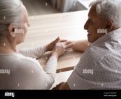 caring elderly grey haired wife giving comfort to old husband 2hn05dt.jpg from old husband
