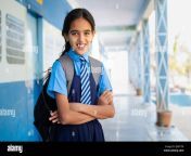 happy smiling girl kid in school uniform confidently standing at corridor with arms crossed by looking at camera concept of education knowledge and 2j0877m.jpg from desi schoolgirl ref com