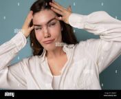 attractive amusing funny joyful positive cute nice adorable tender young curly brunette woman wearing white shirt isolated on bl 2jmja3y.jpg from jmja