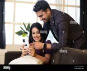 happy smiling indian couple watching videos or shopping online on mobile phone while talking each other at home concept of dating romantic 2mfpma9.jpg from indiian husband watch her wife fucked
