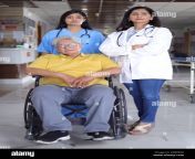 indian nurse looking very happy greeting a senior patient in a wheelchair at the hospital and smiling healthcare concepts 2r98eax.jpg from indian nars se