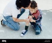 mother nurses a bleeding knee of her son after an accident in a playground m44k10.jpg from mother and son accidental