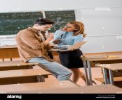 male student and female teacher in formal wear using laptop during lesson in classroom r75y58.jpg from lady teacher and male student sex latest raping videos
