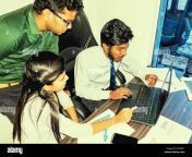 team of two young men and one indian woman in the office at the desk with laptop graphs on sheets ond smartphone rh4nf1.jpg from indian one woman two men sexengineering college sex mms leaked hidden cam selfiectress hansika motwani sex video download origina