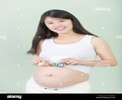 young pretty chinese pregnant woman holds her belly tcx2eg.jpg from pregnant china rap jo sex xxx