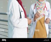 serious two female asian hijab doctor discuss and studying about patients document on the hospital room t1txbe.jpg from hijab by doc