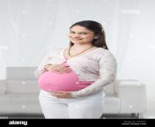 pregnant woman standing and smiling w70p07.jpg from indian pregg